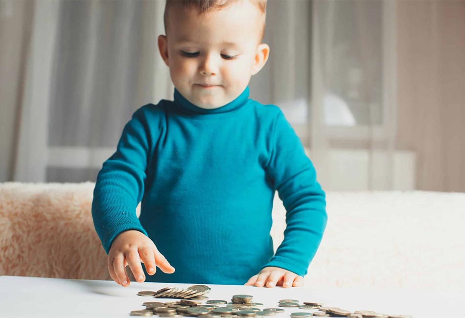 Toddler Playing With Coins At Home