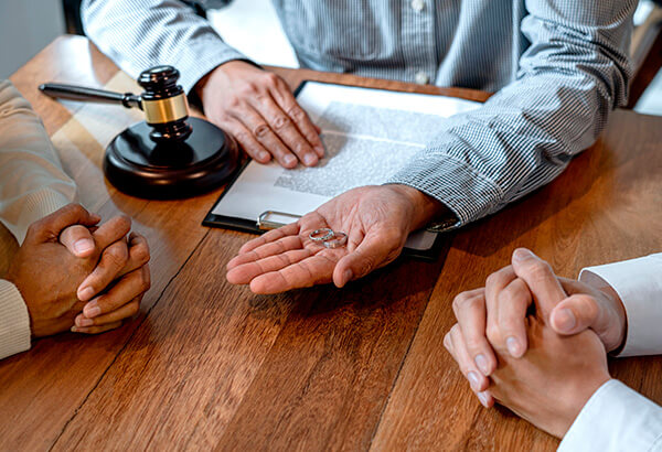 Attorney Holding Rings And Divorce Agreement 