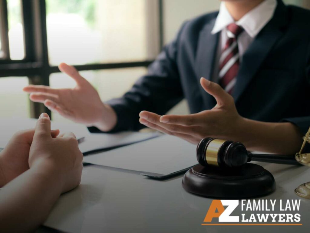 A lawyer discussing a case with a client in an office, with a focus on family law in Arizona, featuring a gavel on the desk.