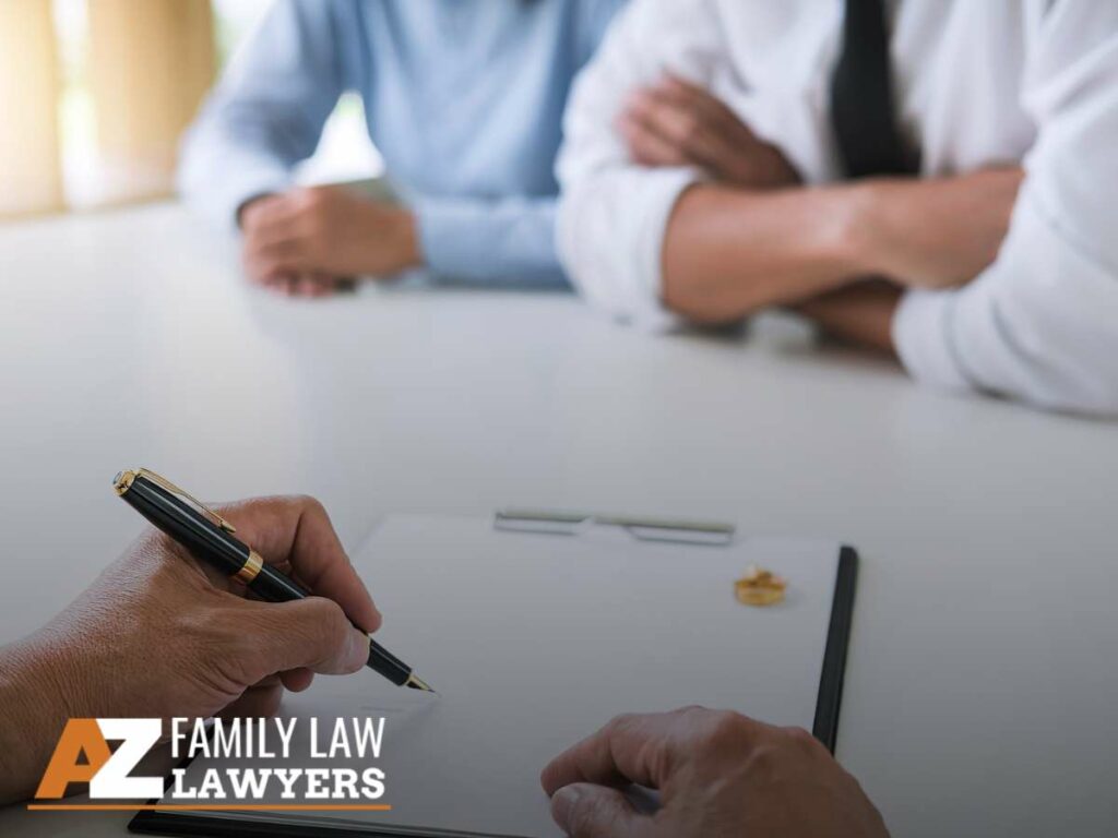 Couple signing divorce papers with AZ Family Law Lawyers.