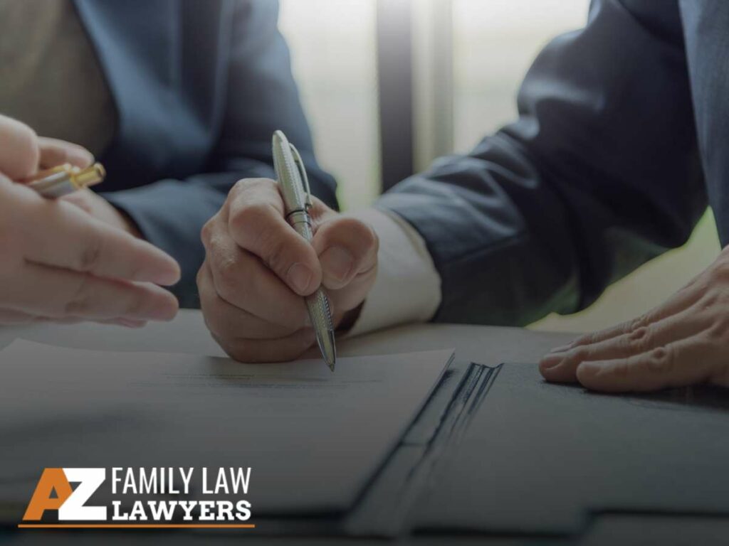 Two individuals signing divorce documents in an Arizona Divorce case